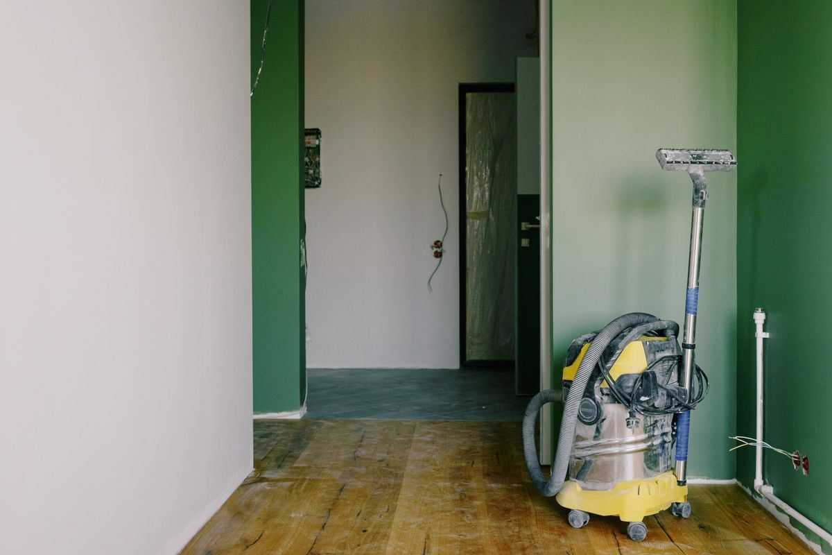 Industrial vacuum cleaning dust from a newly renovated commercial room