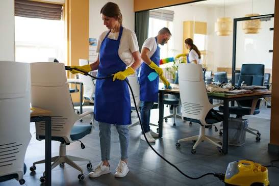 Cleaner disinfecting an office workspace in Northern Virginia