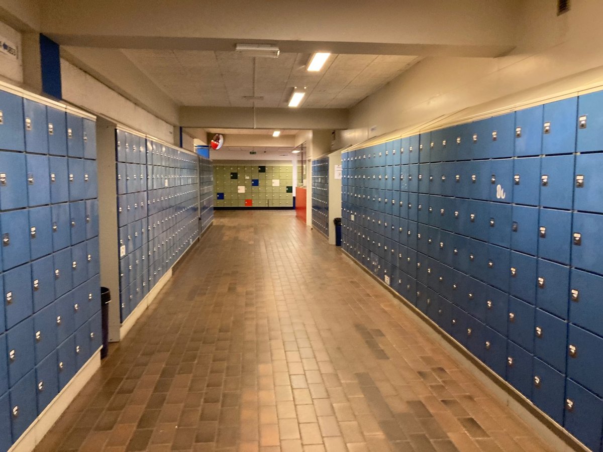 Cleaner sanitizing desks in a school classroom in Maryland